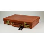 A Tan Leather Attache Case, by Simpson of London, unused but slightly shop soiled, 14ins x 12ins,