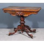 A Victorian Mahogany Tea Table, with moulded edge to top, the shaped apron carved with leaf scroll