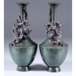 A Pair of Japanese Green and Brown Patinated Bronze Vases, Meiji Period, each cast with a dragon