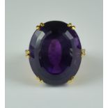 An Amethyst and Diamond Ring, Modern, 18ct gold set with a central faceted amethyst stone,