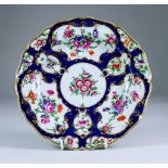 A Worcester Plate of Shaped Outline, Circa 1770, enamelled in colours and gilt with flowers within