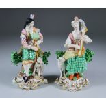 A Pair of English Porcelain Figures, 19th Century, of a lady playing a mandolin and a gentleman