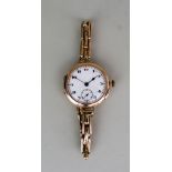 A Lady's Manual Wind Wristwatch, 9ct Gold case, 31ins diameter, the white dial with black Arabic