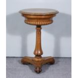 An Early Victorian Pollard Oak Circular Teapoy, the lifting top enclosing space for four containers,
