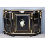 A 19th Century Ebonised, Gilt Brass and Porcelain Mounted Credenza, with bowed ends, the whole