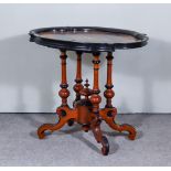 A Victorian Figured Walnut and Ebonised Occasional Table of Lobed Outline, the top inlaid with