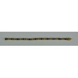 A Sapphire and Diamond Line Bracelet, Modern, 18ct gold set with eleven cabochon sapphires,
