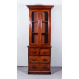 A Victorian Mahogany Bookcase, of narrow proportions, the upper part with moulded cornice, fitted