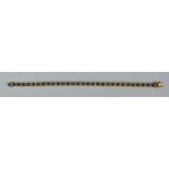 A Sapphire and Diamond Line Bracelet, Modern, yellow metal set with thirty faceted sapphire