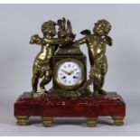 A Late 19th Century French Bronze and Rouge Marble Mantel Clock, No 141 55, the 3.75ins white enamel