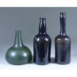 An English Onion-Shaped Glass Wine Bottle, Early 18th Century, of olive green tint, 7ins high, a