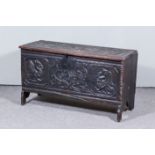 An Old Panelled Oak Coffer, with single plank top, later carved with spurious date 1633 and pair