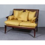 A Mahogany Framed Two-Seat Settee of "Regency" Design, with cane panelled back and sides, reeded