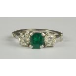An Emerald and Diamond Three Stone Ring, Modern, 18ct white gold, set with a centre emerald,