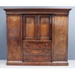 A Victorian Figured Mahogany Breakfront Wardrobe, with moulded cornice, fitted central recessed