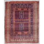 An Early 20th Century Turkmen Enzi Rug, woven in navy blue, rose and ivory, with panels of hooked