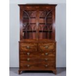 A George IV Figured Mahogany Secretaire Bookcase, the upper part with moulded cornice, fitted