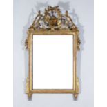 A 19th Century French Gilt Wall Mirror, cresting carved with wreath, musical trophies and scroll
