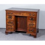 A George III Mahogany Kneehole Dressing Table, with moulded edge to top, fitted seven drawers and