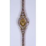 A Lady's Farsi Manual Wind Watch, 18ct gold set with approximately 8ct of brilliant cut white