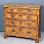 An 18th Century Walnut Bachelor's Chest, the baize lined folding top and drawer fronts inlaid with