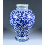An Italian Blue and White Maiolica Vase, 18th/19th Century, painted all over with stylised leaf
