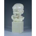 Felix Guis (1887-1972) - Cream glazed pottery bust of a smiling child with a garland of ivy in their