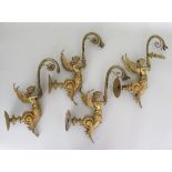 Four Cast Brass Wall Lights, Early 20th Century, modelled as fabled creatures, half-mermaid, half-