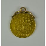 A George III 1779 Spade Guinea, with yellow metal soldered mount, gross weight 9g