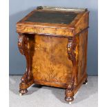 A Victorian Figured Walnut Davenport, inlaid with boxwood arabesques, with gilt brass gallery