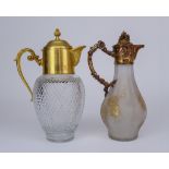 Two Gilt Metal Mounted and Glass Claret Jugs, one with domed cover with floral cast finial, the