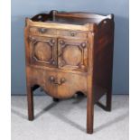 A George III Mahogany Tray Top Bedside Cabinet, the shaped top with two-handle cut-outs, fitted