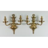 A Pair of Cast Brass Twin Light Wall Lights of French Régence Design, 20th Century, with engraved