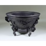 A Chinese Bronzed Metal Circular Basin, cast with dragons, on shishi feet, 10.5ins (26.7cm) diameter