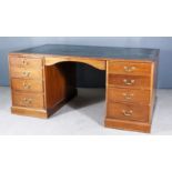 A Victorian Partners Mahogany Kneehole Desk, with green and gilt leather inset to top, fitted