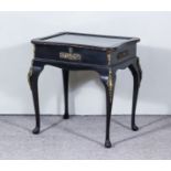 An Early 20th Century Ebonised and Gilt Metal Mounted Rectangular Display Table, the top of