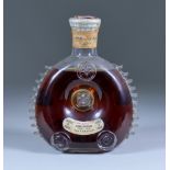 A Bottle of Remy Martin Grande Champagne Cognac, in ornate decanter with moulded seal prunts, and