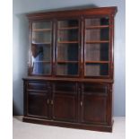 A Late Victorian Dark Walnut Bookcase, the upper part with moulded cornice, fitted nine adjustable