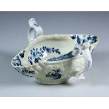 A Worcester Two-Handled Sauce Boat, Circa 1755, painted in blue with a river scape to the