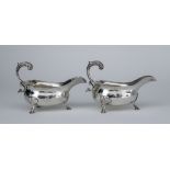 A Pair of 18th Century Silver Sauce Boats, hallmarks rubbed, with shaped rims, leaf capped flying