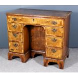 An Early 20th Century Lady's Walnut Kneehole Dressing Table, the quarter veneered top inlaid with