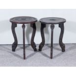 Two Indian Ebonised Hardwood Circular Occasional Tables, carved with geometric and leaf scroll