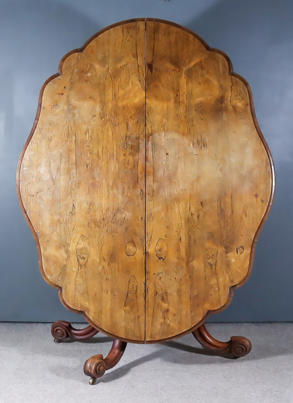 A Victorian Rosewood Oval Breakfast Table, of shaped outline with moulded crossgrain mouldings to