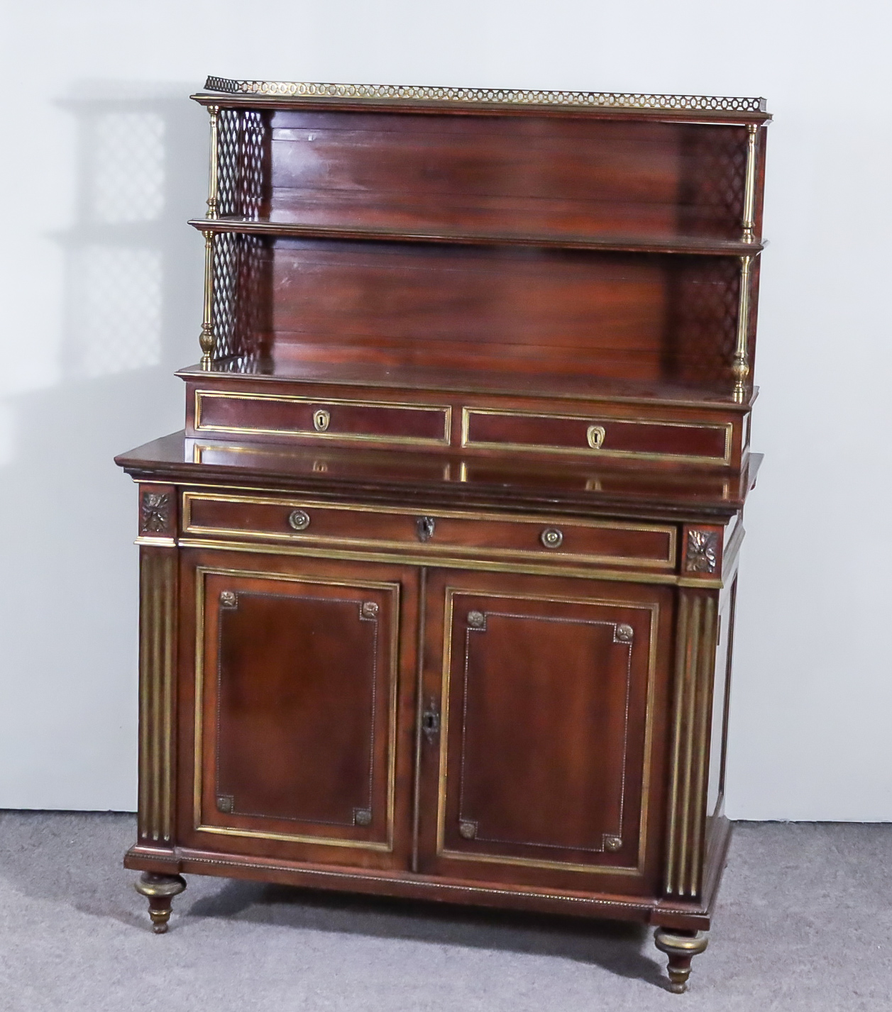 A George IV Mahogany and Gilt Brass Mounted Chiffonier, the upper part with pierced gilt and brass