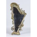 A Continental Brass Dressing Table Mirror Cast with Putti, on a harp shaped framed, late 19th