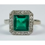 A Emerald and Diamond Ring, Early 20th Century, 18ct white gold set with a centre faceted emerald,