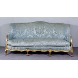 A French Gilt Framed Three Seat Settee of "Louis XV" Design, with shaped back upholstered in blue