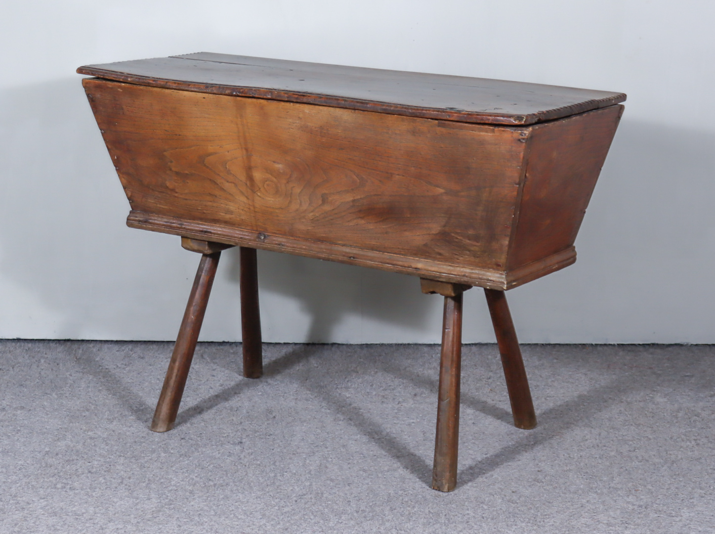 An 18th Century Elm Dough Bin, with moulded and carved edge to top, on turned and splayed legs,