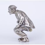 A Continental Cast Silvery Metal and 18ct Gold Crouching Figure, stamped 925, in the form of a man