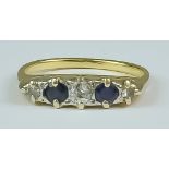 A Sapphire and Diamond Five Stone Ring, Modern, 18ct yellow gold set with two small sapphires,